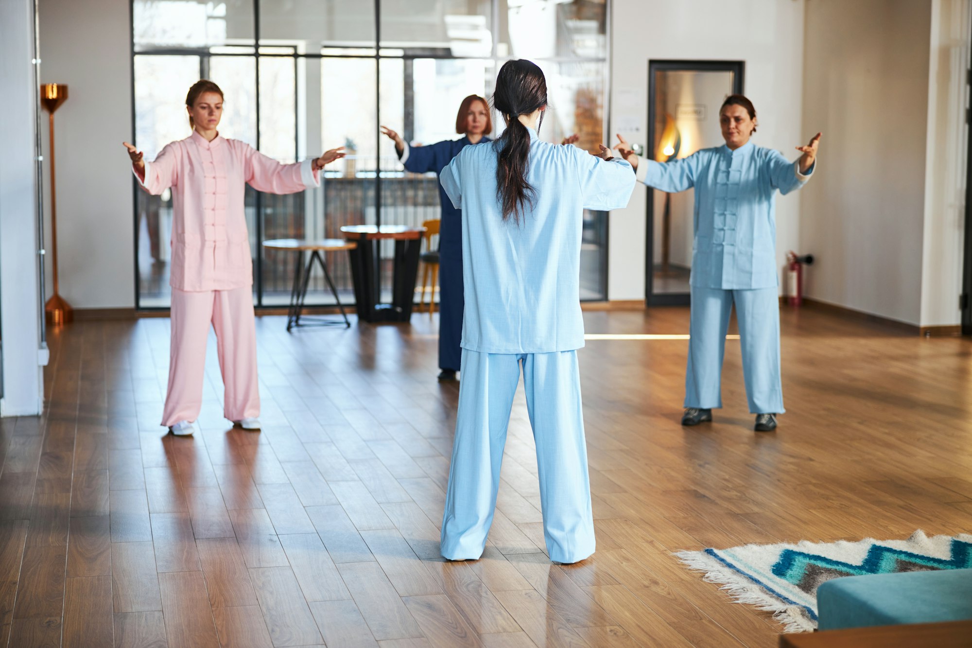 Group of people practicing qigong with their master
