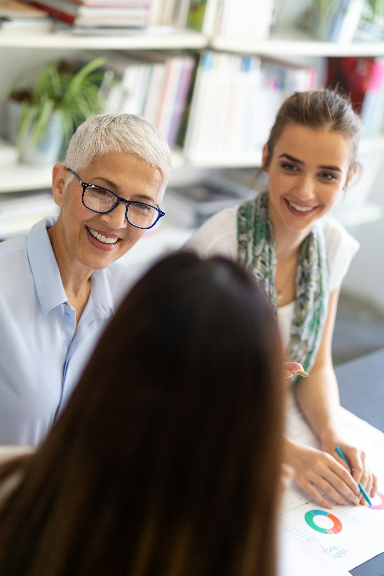 Portrait of happy success business women talking and having fun in office